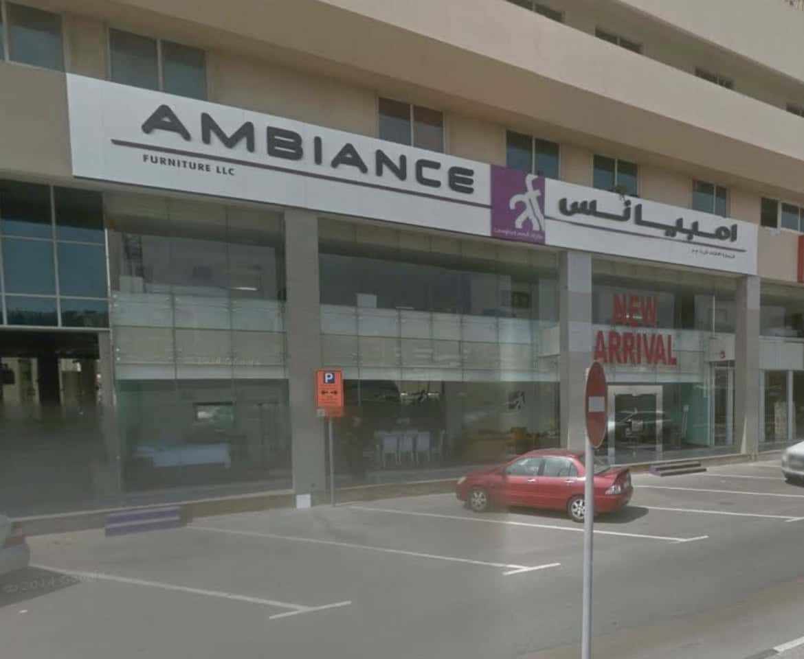 - Modern furniture store exterior branding signage for Ambiance Furniture LLC in downtown shopping mall.