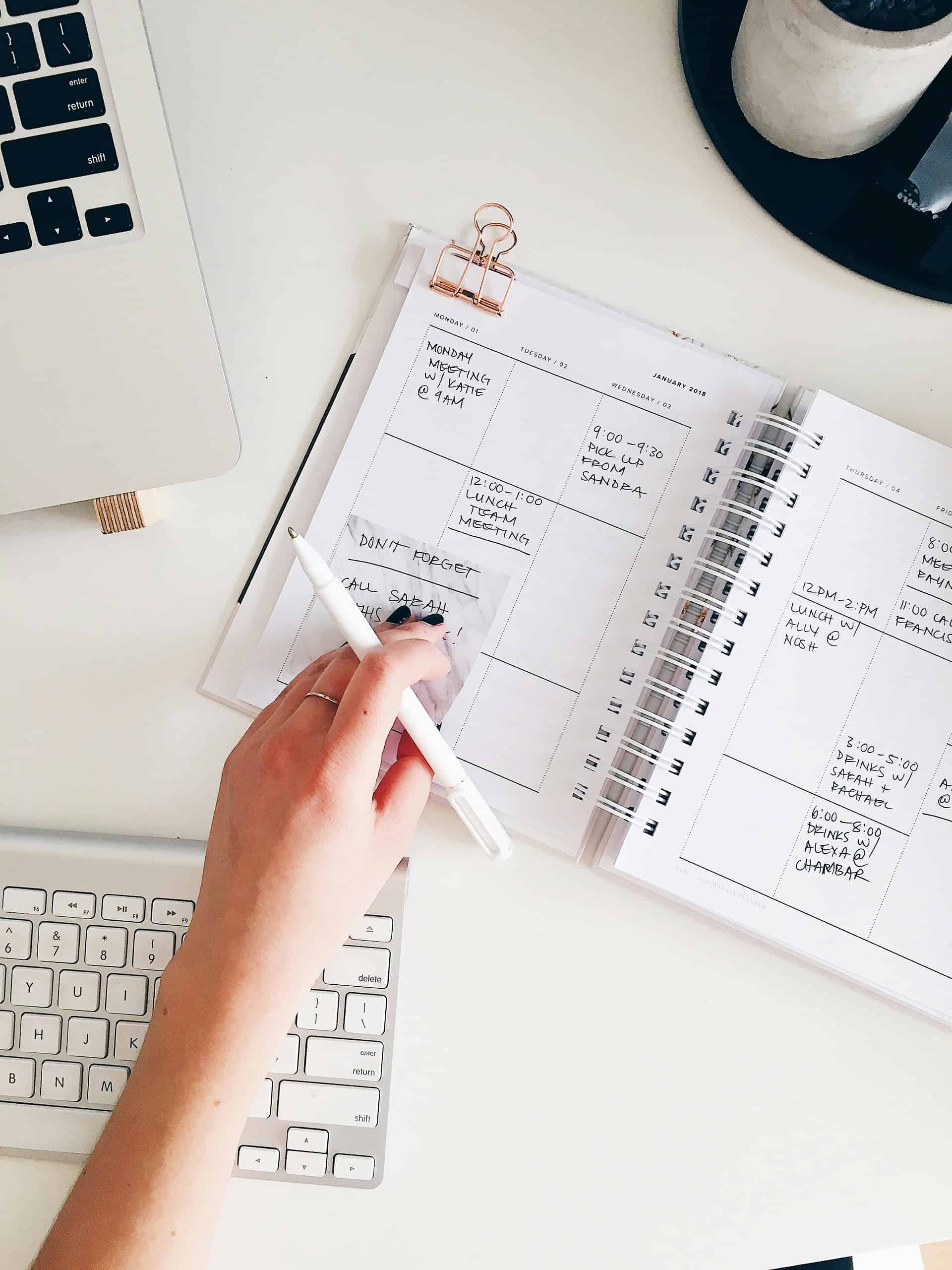 marissa-grootes-flRm0z3MEoA-unsplash Meeting planner with a weekly calendar on a white desk, showing scheduled appointments and reminders.